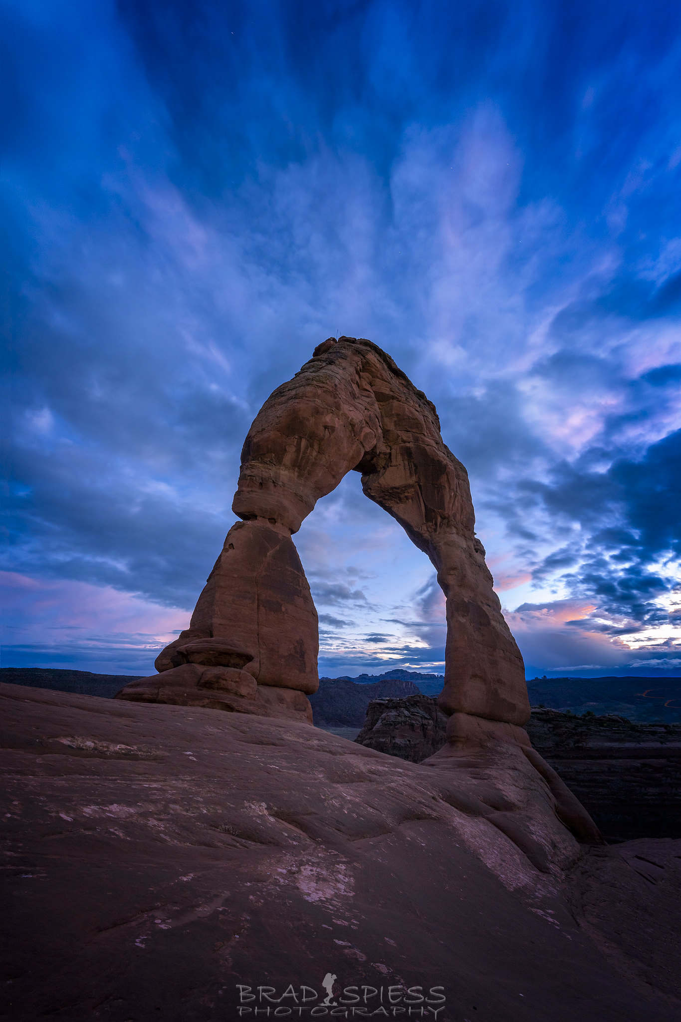 Blue Hour at Delicate Arch with just a touch of pink on the clouds behind it.