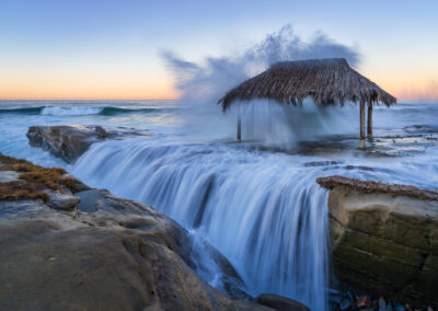 High tides give the surf shack a soaking during sunrise at Windansea in La Jolla, San Diego.